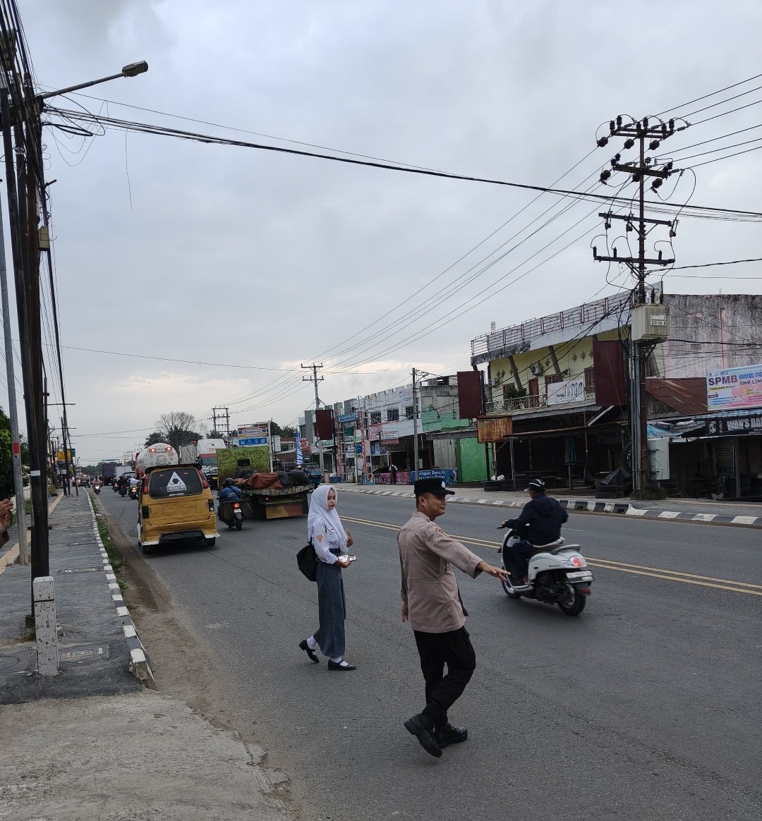 Cegah Kemacetan, Polsek Indralaya Laksanakan Strong Point dan Bantu Pelajar Menyeberang Jalan